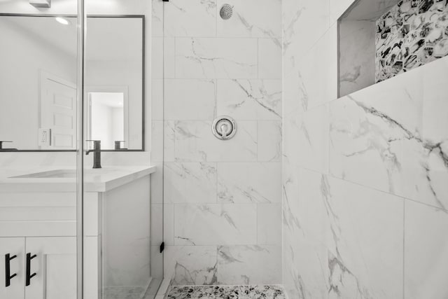 full bath featuring vanity and tiled shower