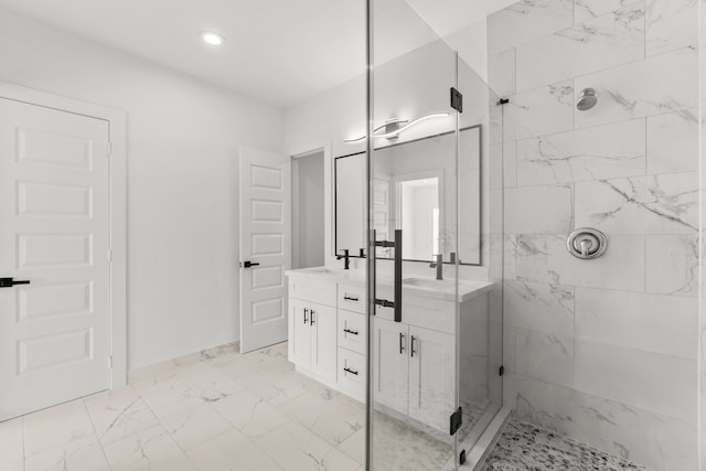 full bathroom featuring marble finish floor, double vanity, a sink, and tiled shower