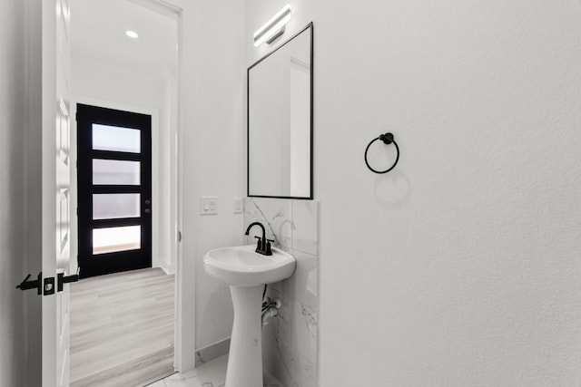 bathroom featuring baseboards and wood finished floors