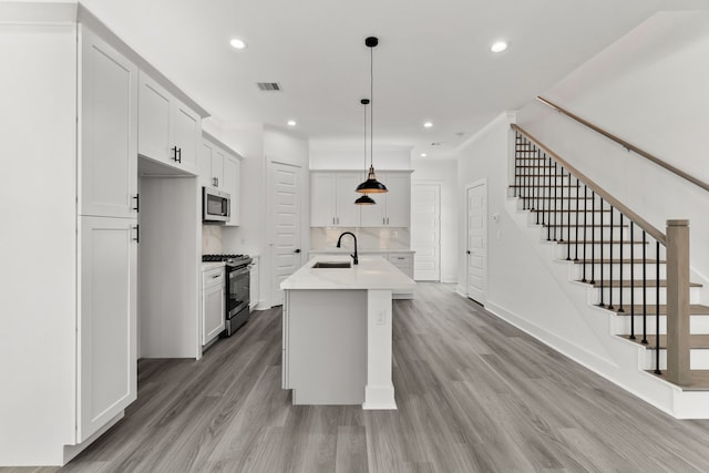 kitchen with light countertops, light wood-style flooring, visible vents, recessed lighting, and appliances with stainless steel finishes
