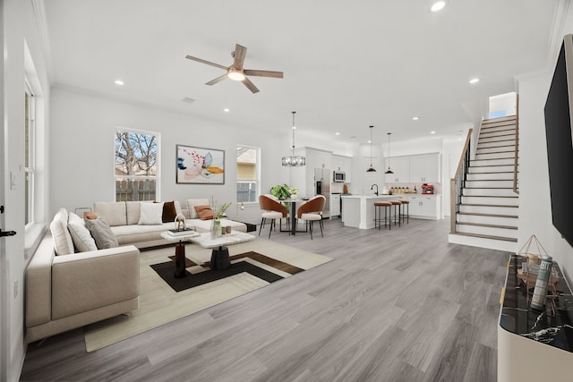 living room with wood finished floors, recessed lighting, stairs, and ceiling fan