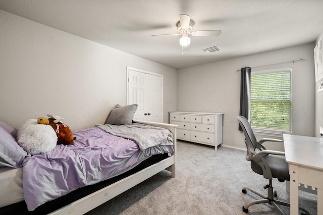 bedroom featuring ceiling fan, visible vents, and light colored carpet