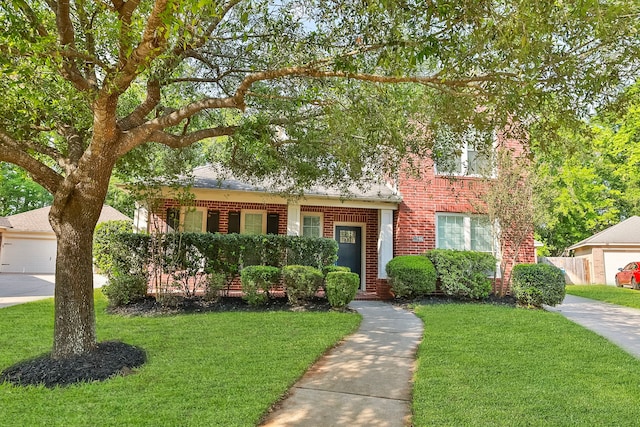 obstructed view of property featuring brick siding and a front lawn