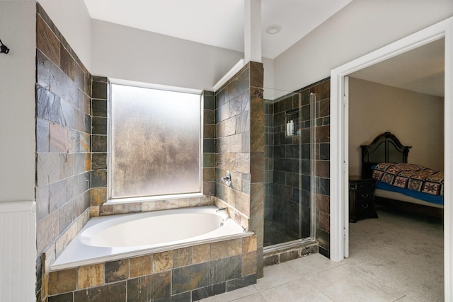 ensuite bathroom with a bath, connected bathroom, a shower stall, and tile patterned flooring
