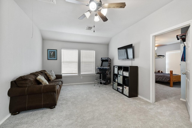living area featuring ceiling fan, baseboards, visible vents, and carpet flooring