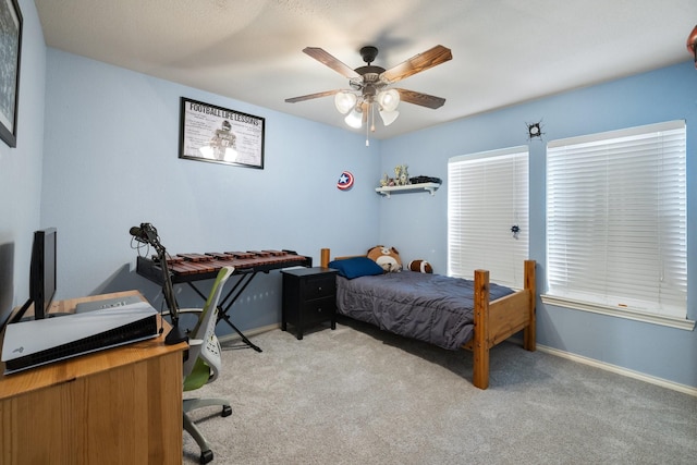 carpeted bedroom featuring baseboards and a ceiling fan