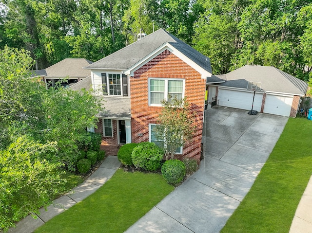 view of front of house featuring a front lawn, brick siding, and a detached garage
