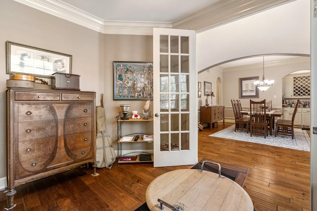 8408 Grand Lake Estates Dr, Montgomery, TX 77316 - living area featuring ornamental molding, arched walkways, a notable chandelier, and wood-type flooring