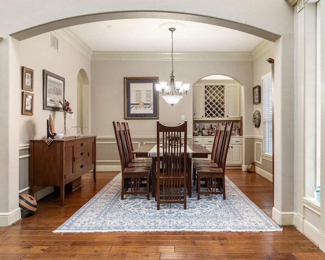 8408 Grand Lake Estates Dr, Montgomery, TX 77316 - dining space with visible vents, ornamental molding, arched walkways, dark wood-style floors, and a notable chandelier