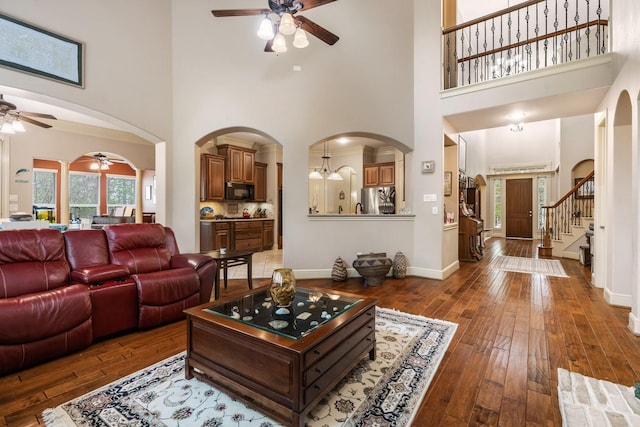 8408 Grand Lake Estates Dr, Montgomery, TX 77316 - living room with hardwood / wood-style floors, arched walkways, and ceiling fan