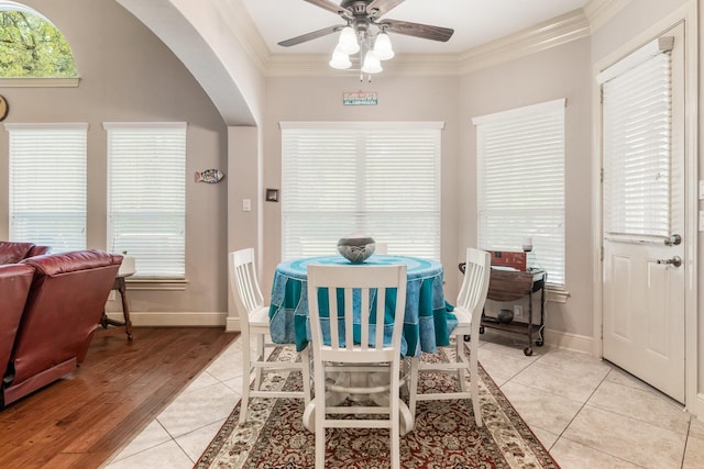 8408 Grand Lake Estates Dr, Montgomery, TX 77316 - dining space with light tile patterned floors, ornamental molding, baseboards, arched walkways, and a ceiling fan