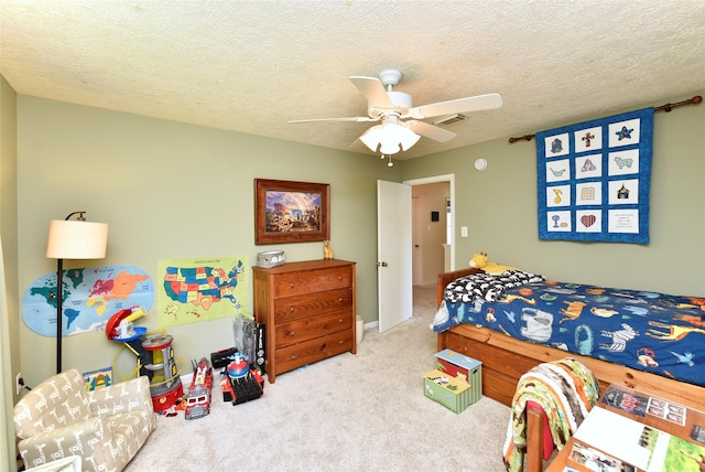 bedroom with visible vents, carpet flooring, a textured ceiling, and ceiling fan