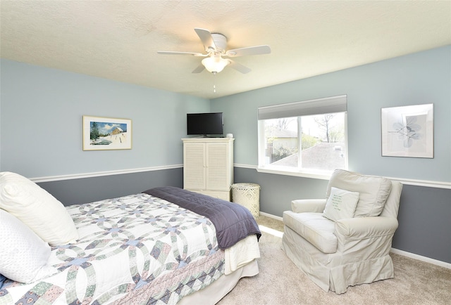 carpeted bedroom featuring ceiling fan and baseboards