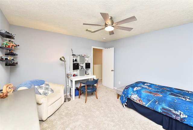 carpeted bedroom featuring visible vents, a textured ceiling, and ceiling fan