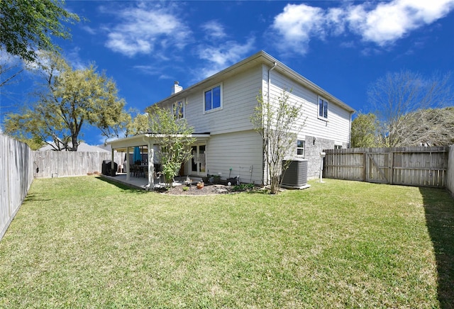back of property with central air condition unit, a yard, a patio area, and a fenced backyard