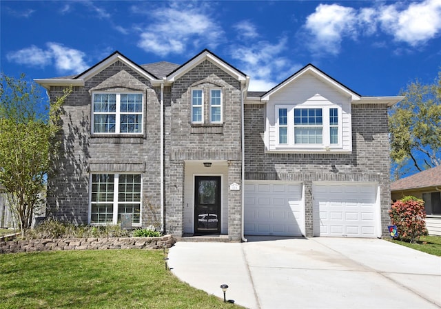 traditional home featuring brick siding, driveway, a front yard, and a garage