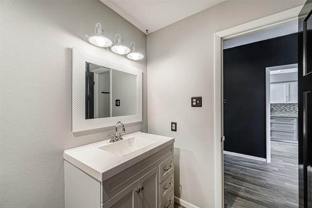 3226 Poe Dr, Montgomery, TX 77356 - bathroom featuring wood finished floors, vanity, and baseboards