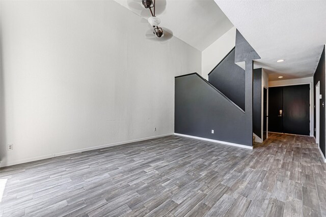 3226 Poe Dr, Montgomery, TX 77356 - unfurnished living room with stairs, baseboards, and wood finished floors
