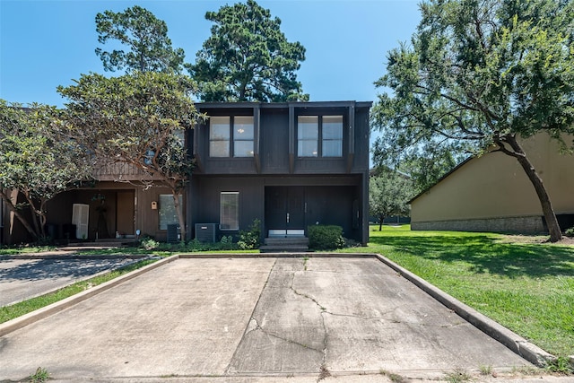 3226 Poe Dr, Montgomery, TX 77356 - view of front of house with a front yard and central air condition unit