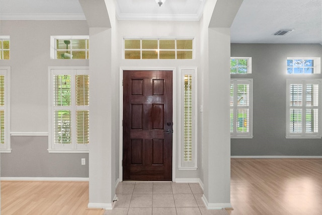 31 Trilling Bird Pl, The Woodlands, TX 77384 - foyer entrance featuring arched walkways, ornamental molding, a towering ceiling, and wood finished floors