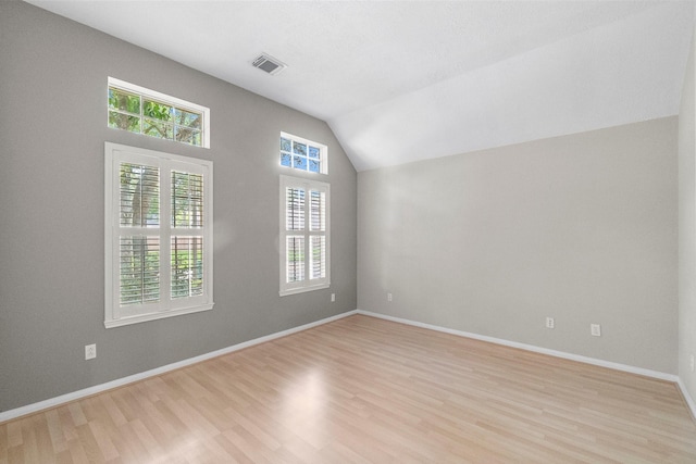 31 Trilling Bird Pl, The Woodlands, TX 77384 - spare room featuring light wood-type flooring and vaulted ceiling