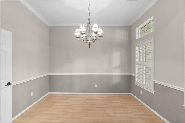 31 Trilling Bird Pl, The Woodlands, TX 77384 - empty room with light wood-style flooring, a chandelier, and ornamental molding