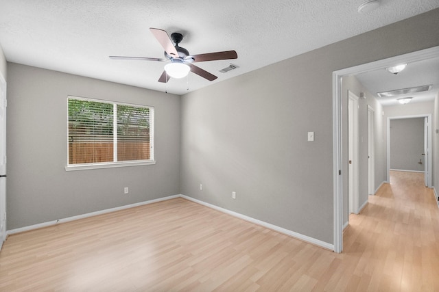 31 Trilling Bird Pl, The Woodlands, TX 77384 - spare room featuring light wood-type flooring, ceiling fan, and a textured ceiling