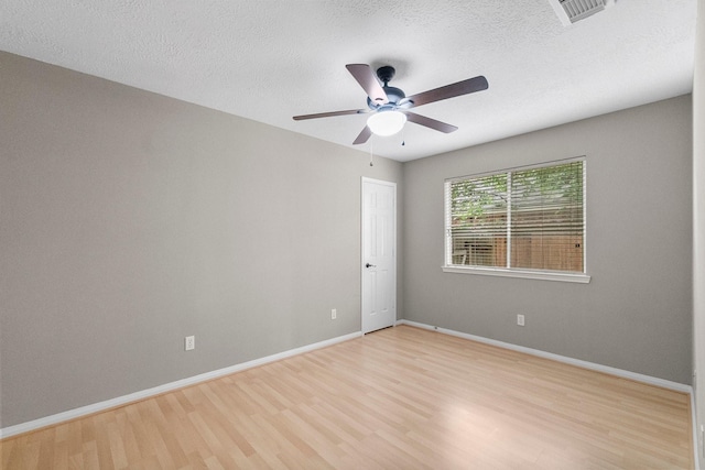 31 Trilling Bird Pl, The Woodlands, TX 77384 - empty room with light wood-style floors, a ceiling fan, and a textured ceiling