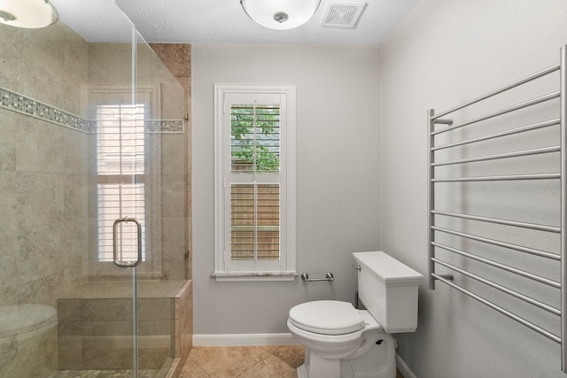 31 Trilling Bird Pl, The Woodlands, TX 77384 - bathroom with a shower stall, a towel warmer, and tile patterned flooring