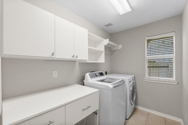 31 Trilling Bird Pl, The Woodlands, TX 77384 - washroom featuring cabinet space, independent washer and dryer, and light tile patterned floors