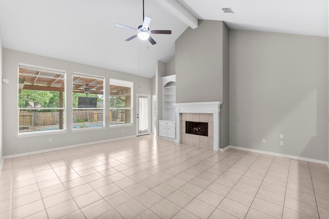 31 Trilling Bird Pl, The Woodlands, TX 77384 - unfurnished living room featuring ceiling fan, beam ceiling, a tile fireplace, built in features, and high vaulted ceiling