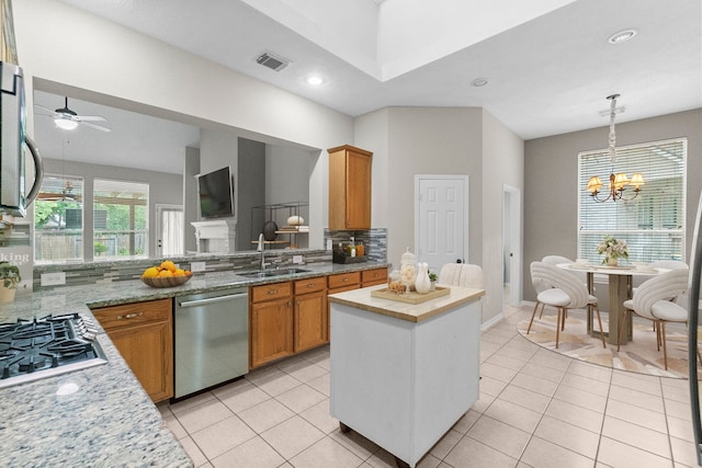 31 Trilling Bird Pl, The Woodlands, TX 77384 - kitchen with appliances with stainless steel finishes, tasteful backsplash, a chandelier, light tile patterned floors, and recessed lighting