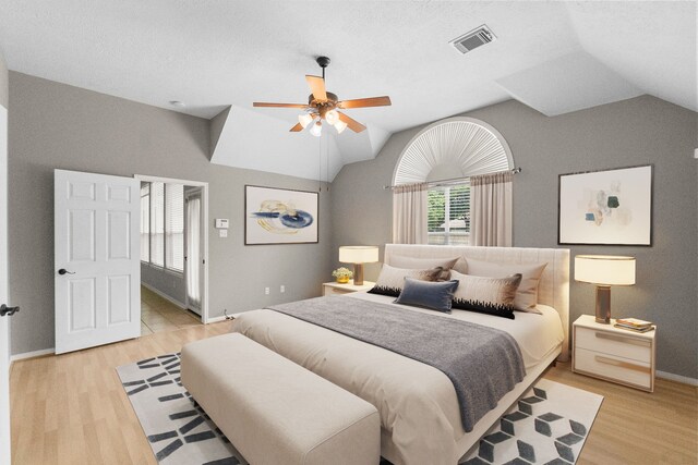 31 Trilling Bird Pl, The Woodlands, TX 77384 - bedroom featuring vaulted ceiling, light wood-style floors, and a ceiling fan