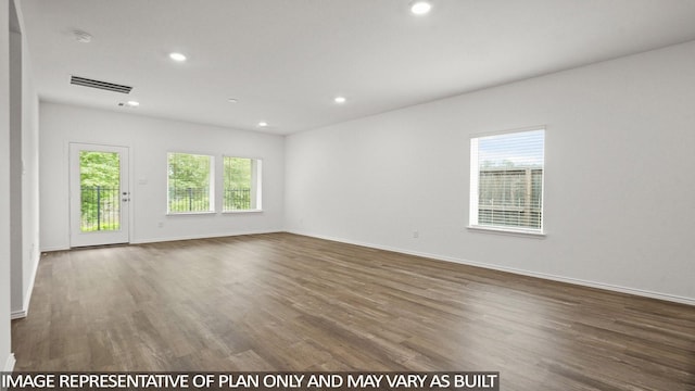 522 Belle Springs Ln, Conroe, TX 77301 - unfurnished room with a healthy amount of sunlight, recessed lighting, wood finished floors, and visible vents