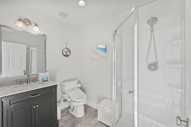 17431 Bristow Dr, Galveston, TX 77554 - bathroom with vanity, toilet, a stall shower, visible vents, and wood finished floors