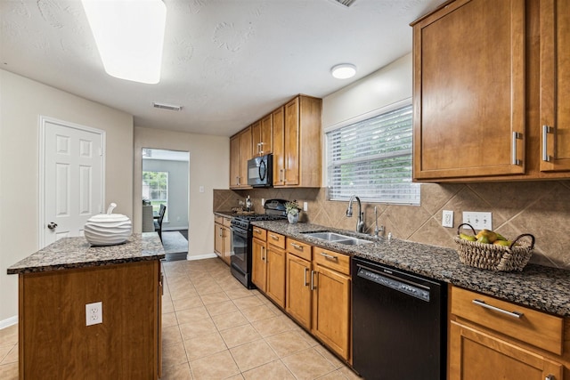 7107 Grant Dr, Magnolia, TX 77354 - kitchen featuring black appliances, a sink, tasteful backsplash, and light tile patterned flooring