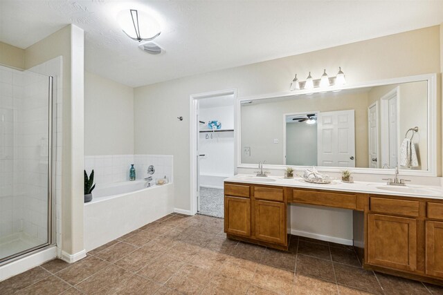 7107 Grant Dr, Magnolia, TX 77354 - full bath with a bath, double vanity, a shower stall, and a ceiling fan
