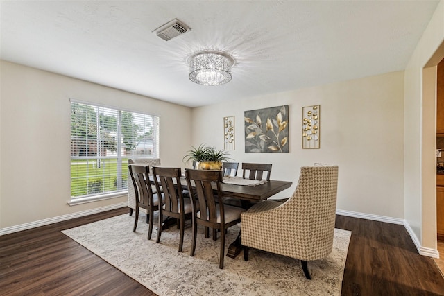 7107 Grant Dr, Magnolia, TX 77354 - dining area featuring a chandelier, baseboards, and wood finished floors