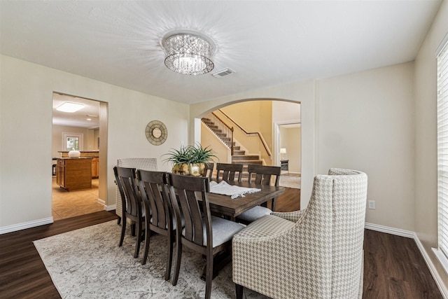 7107 Grant Dr, Magnolia, TX 77354 - dining room with arched walkways, plenty of natural light, and dark wood-style floors