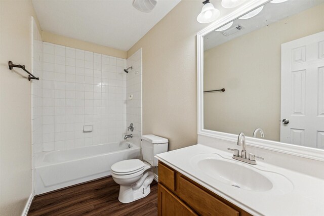7107 Grant Dr, Magnolia, TX 77354 - full bathroom featuring toilet, wood finished floors, vanity, and shower / washtub combination
