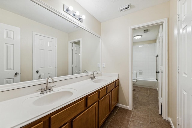 7107 Grant Dr, Magnolia, TX 77354 - full bath with double vanity, tile patterned flooring, toilet, shower / bathtub combination, and baseboards