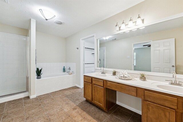 7107 Grant Dr, Magnolia, TX 77354 - bathroom featuring a bath, double vanity, a shower stall, and tile patterned floors