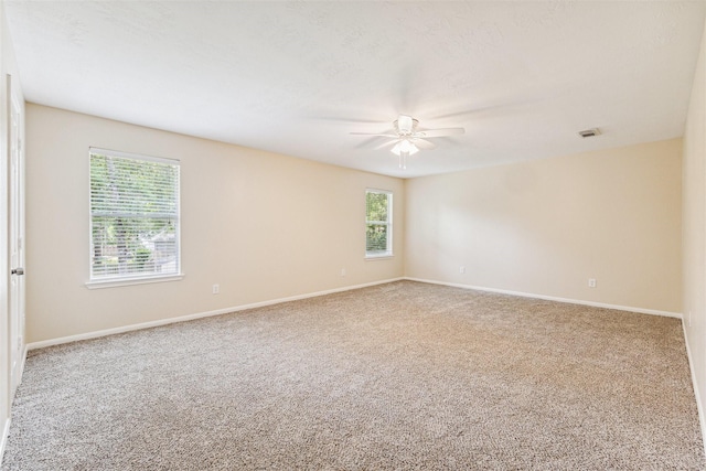 7107 Grant Dr, Magnolia, TX 77354 - empty room with a ceiling fan, carpet flooring, and plenty of natural light