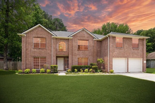 7107 Grant Dr, Magnolia, TX 77354 - view of front of home with concrete driveway, brick siding, and a garage