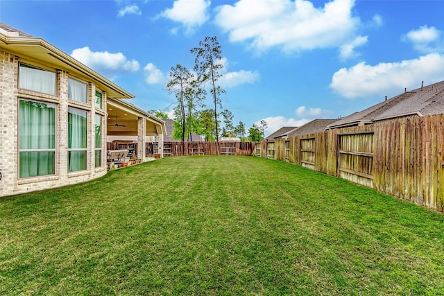 12306 Wildrye Prairie Trce, Humble, TX 77346 - view of yard featuring a fenced backyard, a patio, and a ceiling fan