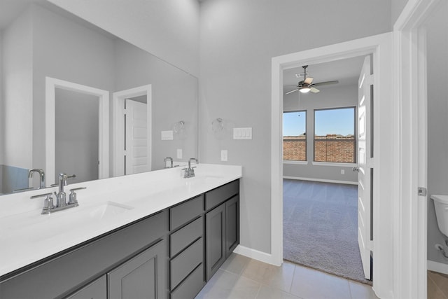 5028 Marcasca Dr, Katy, TX 77493 - bathroom featuring double vanity, baseboards, a sink, and ceiling fan