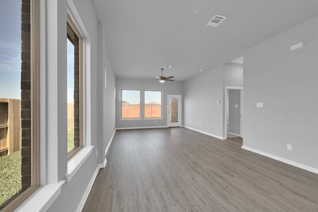 5028 Marcasca Dr, Katy, TX 77493 - unfurnished living room featuring wood finished floors, baseboards, a ceiling fan, and visible vents