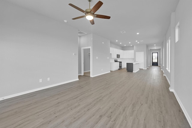 5028 Marcasca Dr, Katy, TX 77493 - unfurnished living room featuring baseboards, recessed lighting, light wood-style floors, visible vents, and ceiling fan