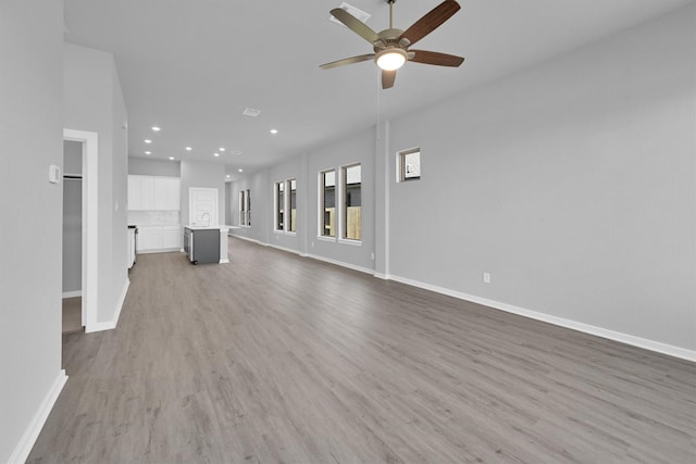 5028 Marcasca Dr, Katy, TX 77493 - unfurnished living room with wood finished floors, ceiling fan, baseboards, and recessed lighting