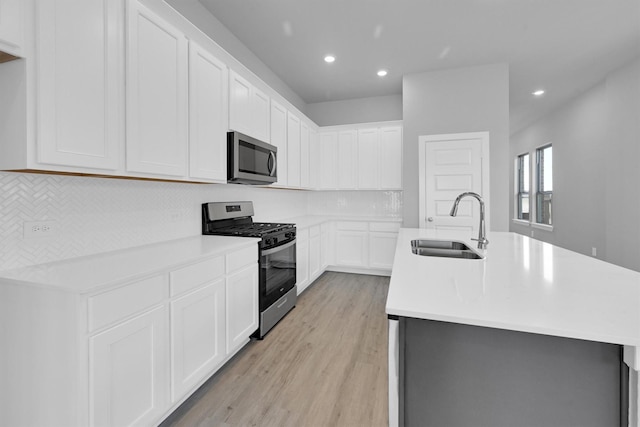 5028 Marcasca Dr, Katy, TX 77493 - kitchen featuring light wood-style floors, recessed lighting, a sink, stainless steel appliances, and backsplash